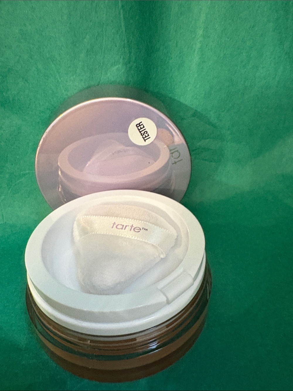 tarte body glow jar with lavender lid and white puff